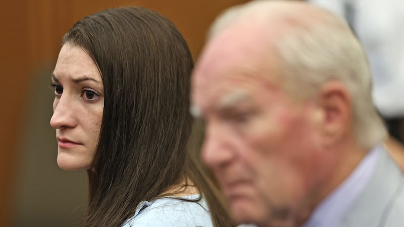 Lindsay Clancy and attorney Kevin Reddington watch as Judge William Sullivan tells the jury to...