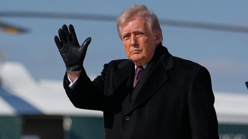 President Donald Trump waves after arriving on Air Force One, Wednesday, March 18, 2026, at...