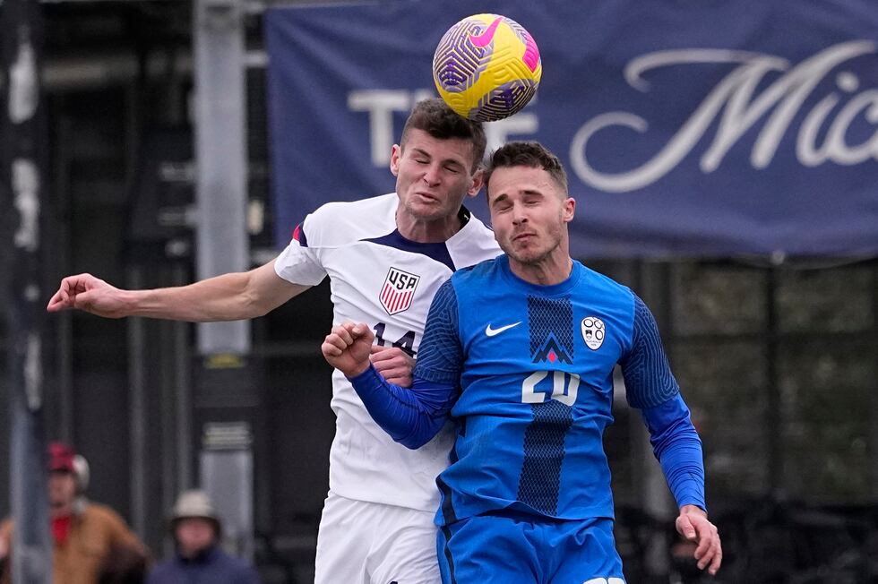 United States midfielder Sean Zawadzki (14) and Slovenia midfielderJan Repas battle for a head...