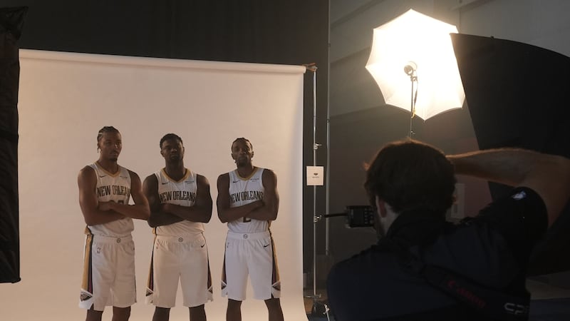 New Orleans Pelicans forward Zion Williamson, center, poses for photos with forwards Trey...