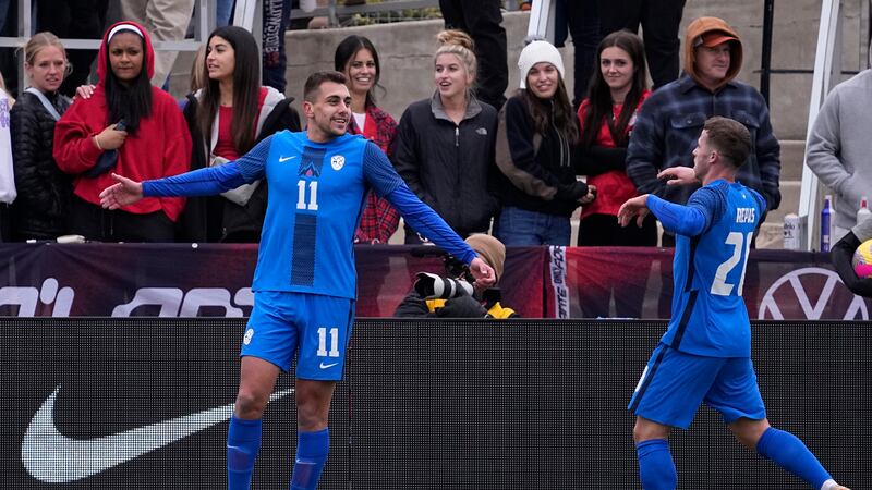 Slovenia forward Nejc Gradisar (11) celebrates his goal with teammate Matija Kavcic (21)...