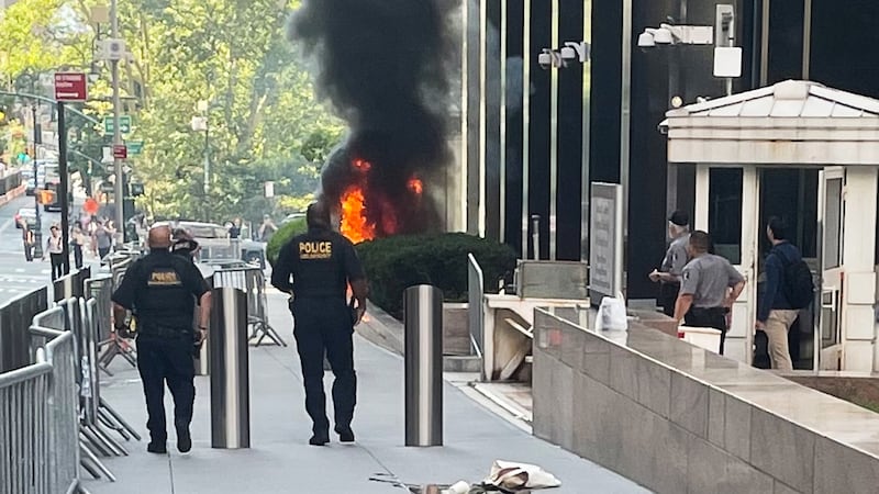 This photo provided by Robert Sullivan shows black smoke and flames in front of 26 Federal...