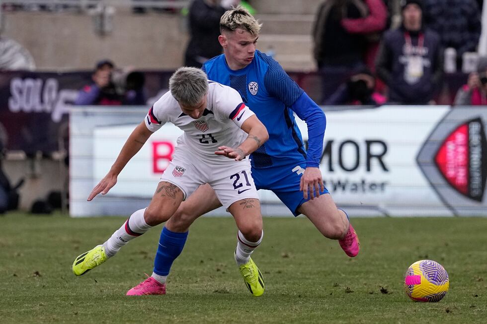United States defender John Tolkin (21) and Slovenia defender Srdan. Kuzmic (3) battle for...