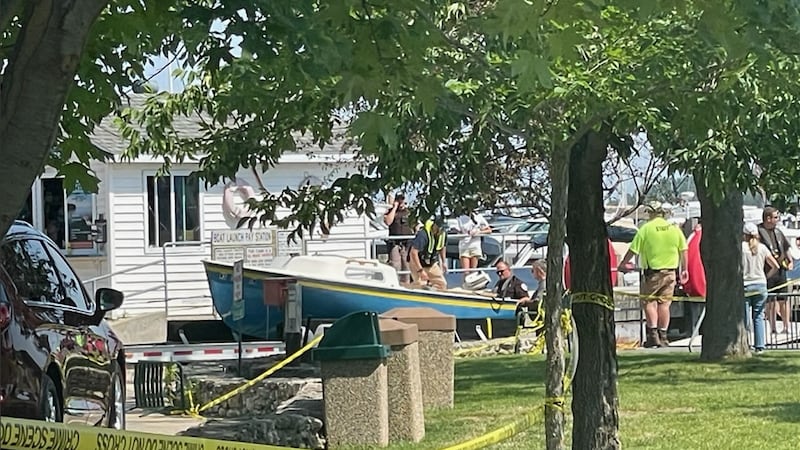 Investigators searching for a missing father and his two young children look over their...