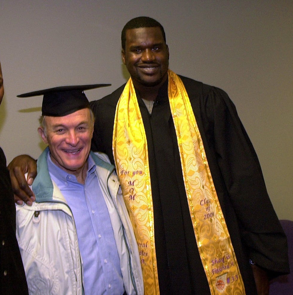 NBA star Shaquille O'Neal poses with his former college coach Dale Brown after graduation...