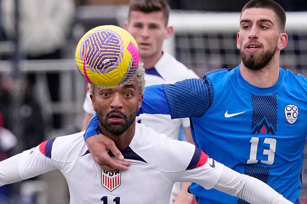 United States midfielder Timmy Tillman (11) is grabbed by Slovenia midfielder Adrian Zeljkovic...
