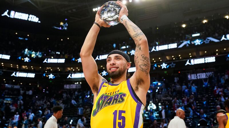 Pelicans guard Jose Alvarado hoists his Rising Stars MVP trophy after making the game-winning...