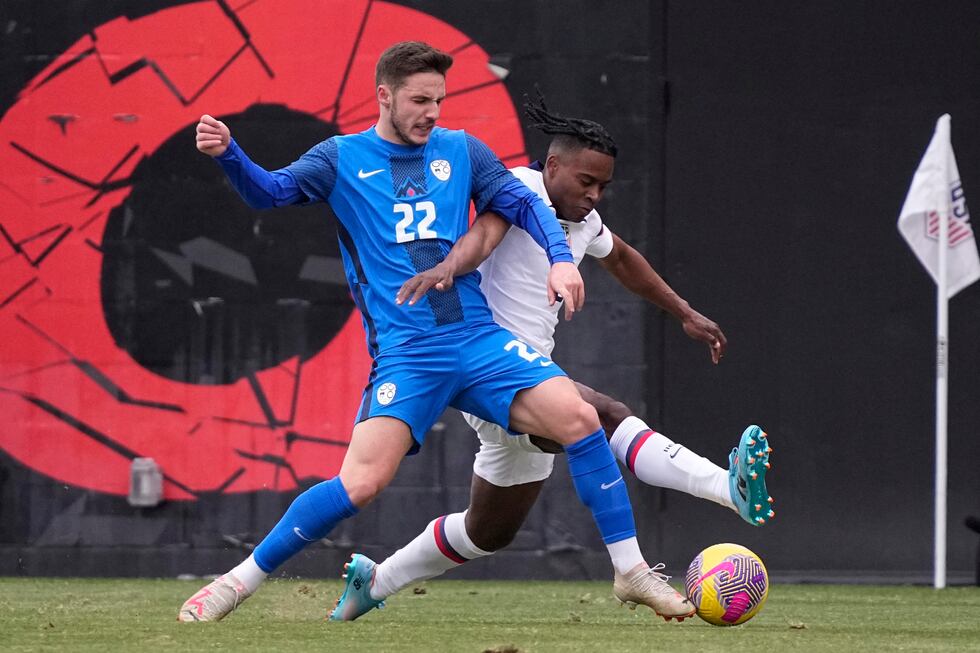 Slovenia midfielder Tamar Svetlin (22) and United States defender DeJuan Jones (5) battle for...