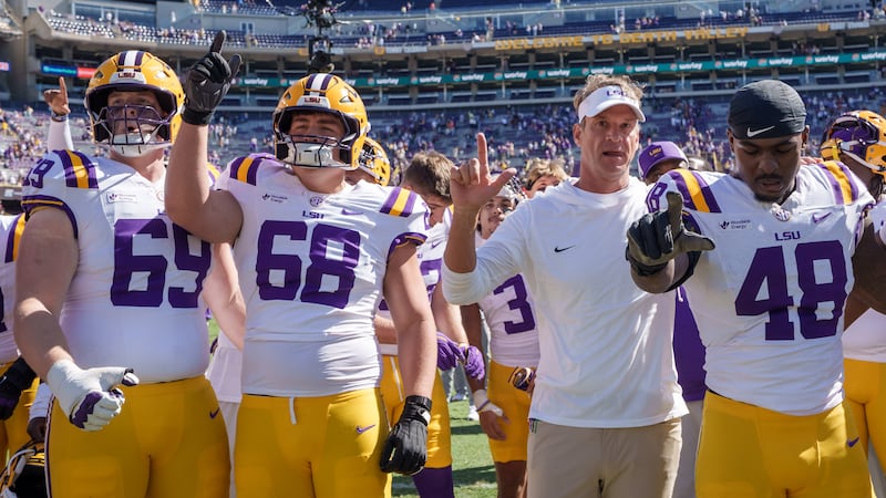 LSU coach Lane Kiffin celebrates Saturday's 31-0 shutout of Mississippi State with offensive...